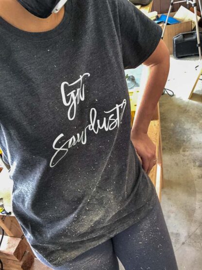 woman covered in sawdust with woodworking t-shirt