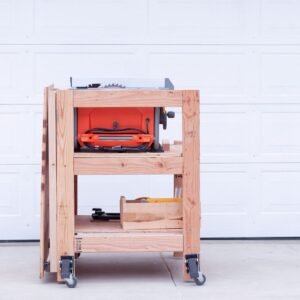 Table saw stand with outfeed table folded down