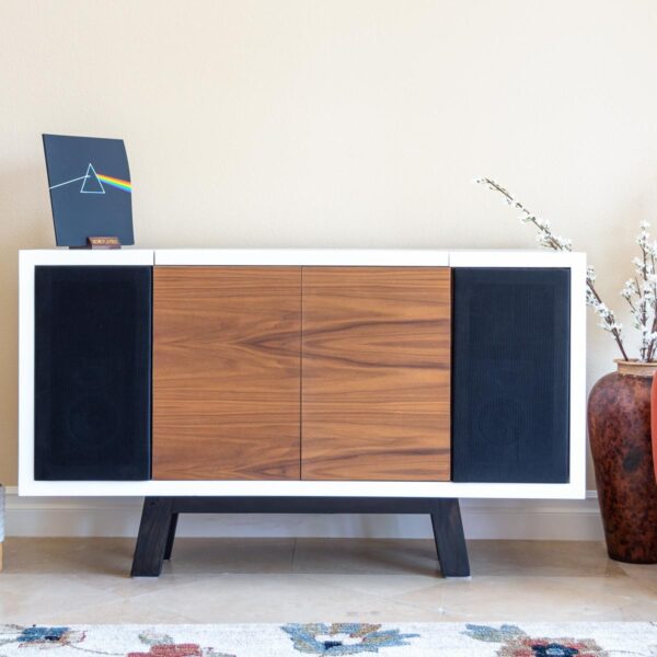 Brown and white record player cabinet with black feet in a room